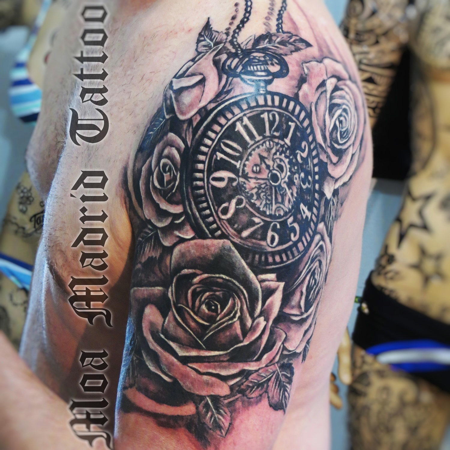 Tatuaje de reloj de bolsillo rodeado de rosas hecho en el brazo