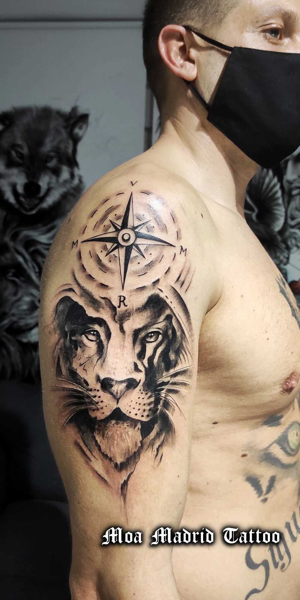 Tattoo doble de rosa de los vientos y león en el brazo